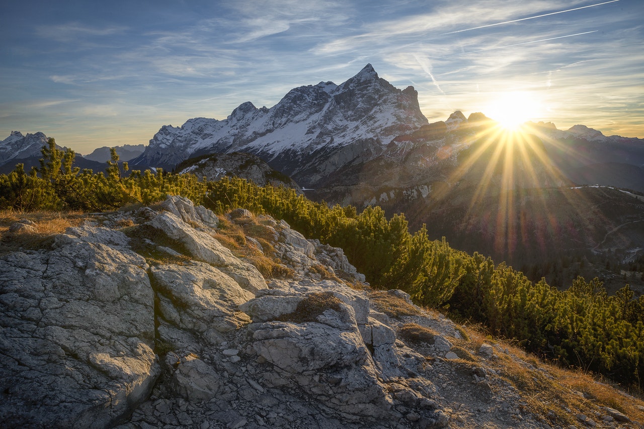 Photograph of snow-capped and rocky mountains.